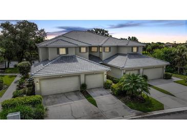 Attractive three-unit building, featuring attached garages and lush landscaping at 3332 Grand Vista Ct # 101, Port Charlotte, FL 33953