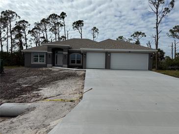 New construction home with three-car garage and neutral exterior at 49 Tee View Rd, Rotonda West, FL 33947