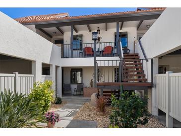 Inviting courtyard featuring well-maintained landscaping, seating areas, and stairs to the upper level condos at 754 Avenida Estancia # 160, Venice, FL 34292