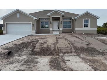 One-story home with attached garage and landscaping at 8347 Ada St, Port Charlotte, FL 33981