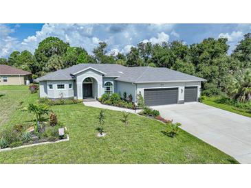 Single-story home with gray roof, landscaping, and a three-car garage at 4767 Maurbach Ter, North Port, FL 34286