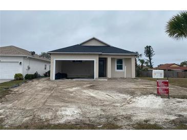Newly constructed one-story home with attached garage and partial landscaping at 4250 Oak Terrace Cir, Port Charlotte, FL 33953