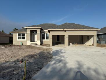 New construction home with a two-car garage and a spacious front yard at 14146 Baracoa Ln, Port Charlotte, FL 33981