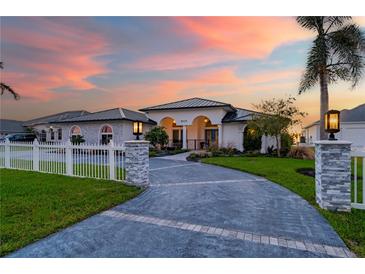 Stunning curb appeal with a landscaped yard and white fence at 5117 Collingswood Blvd, Port Charlotte, FL 33948