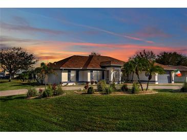 Charming single-story home with a well-manicured lawn, mature landscaping, and a welcoming curb appeal at 98 Seasons Dr, Punta Gorda, FL 33983