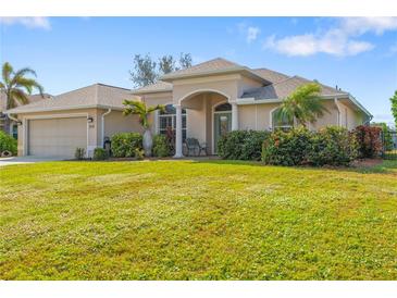 One story house with a two car garage and lush green lawn at 219 White Marsh Ln, Rotonda West, FL 33947