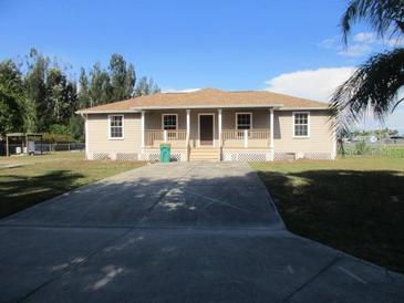 Charming single-story home featuring a welcoming front porch and a spacious front yard at 2410 Lanier Rd, Punta Gorda, FL 33982