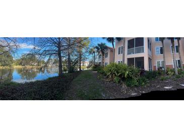 Scenic view of a condo community with a serene lake and lush landscaping on a sunny day at 4178 Central Sarasota Pkwy # 326, Sarasota, FL 34238