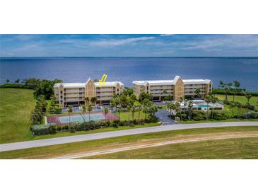 Aerial view of waterfront condo community with tennis courts at 101 N Marion Ct # 133, Punta Gorda, FL 33950