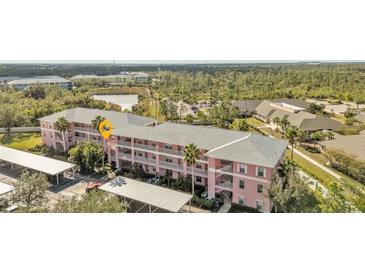 Aerial view of condo building, parking, and landscaping at 2061 Willow Hammock Cir # 204, Punta Gorda, FL 33983