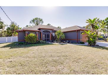 Single-story home with a gray exterior, orange accents, and a well-manicured lawn at 5188 Balmor Ter, North Port, FL 34288