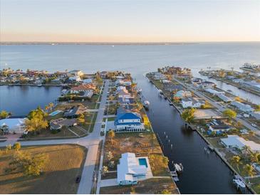 Aerial view of waterfront property with canal access and nearby homes at 174 Severin Se Rd, Port Charlotte, FL 33952