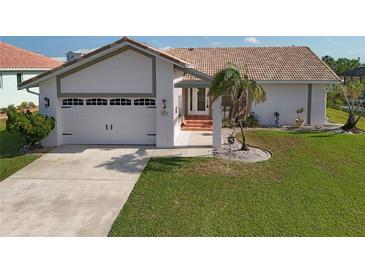 Single-story home with tile roof and two-car garage at 1120 La Palma Ct, Punta Gorda, FL 33950