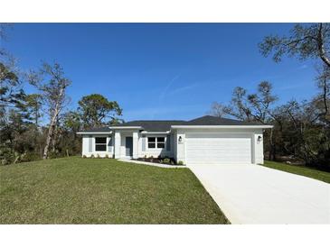 Single-story home with white exterior, grey roof, and attached garage at 1548 El Paso Ave, North Port, FL 34286