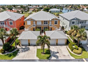 Aerial view of a waterfront community with a focus on a charming yellow building at 2002 Bal Harbor Blvd # 1822, Punta Gorda, FL 33950