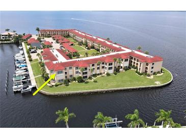 Aerial view of waterfront condo community, showcasing building and boat slips at 1 Colony Point Dr # 3C, Punta Gorda, FL 33950