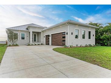 New modern home with attached two-car garage and metal roof at 116 Northshore Ter, Punta Gorda, FL 33980