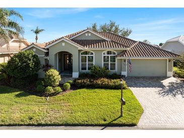 Beautiful home exterior with green walls and tile roof at 13761 Long Lake Ln, Port Charlotte, FL 33953