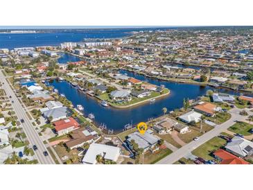 Aerial view showcasing waterfront home with private dock and canal access at 1640 Montia Ct, Punta Gorda, FL 33950