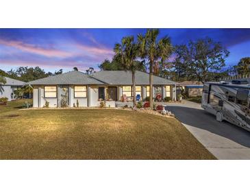 Single-story home with RV parking and landscaping at 18266 Grace Ave, Port Charlotte, FL 33948