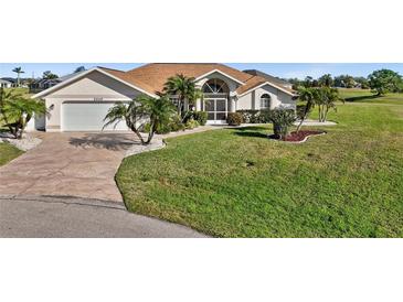 Single-story home with attached garage and landscaped lawn at 2210 Bengal Ct, Punta Gorda, FL 33983