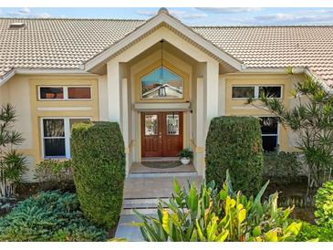 Elegant entryway with double doors and landscaping at 2427 St Davids Island Ct, Punta Gorda, FL 33950