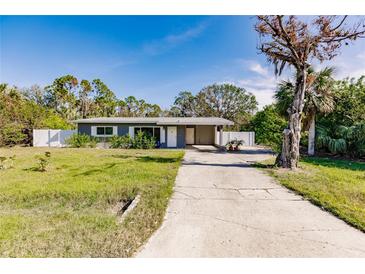 Gray house with a white fence and driveway at 3214 Amanda St, Punta Gorda, FL 33950