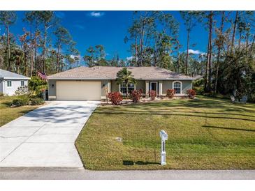 Single-story house with a garage and well-maintained lawn at 4198 Kinlock St, North Port, FL 34286