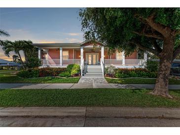 Charming two-story home with a wrap-around porch and landscaped yard at 668 W Olympia Ave, Punta Gorda, FL 33950