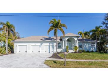 Beautiful waterfront home with three-car garage and lush landscaping at 193 Beeney Se Rd, Port Charlotte, FL 33952