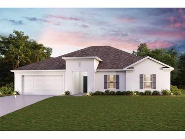 Single-story home with white exterior, gray shutters, and a two-car garage at 2130 Mauritania Rd, Punta Gorda, FL 33983