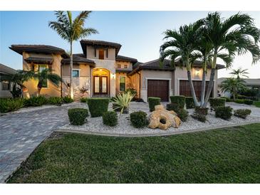 Luxury home with Mediterranean styling, manicured landscaping, and a brick driveway at 2521 Rio Grande Dr, Punta Gorda, FL 33950