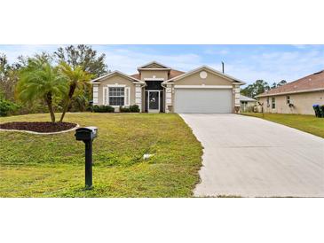 Tan house with a white garage door and palm trees in the front yard at 4465 Kaskin Ave, North Port, FL 34286