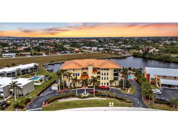 Aerial view of waterfront community with pool and boat slips at 1340 Rock Dove Ct # 135, Punta Gorda, FL 33950