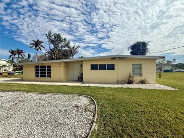 Ranch style home with a well-manicured lawn at 1905 Myrtle Ave, Punta Gorda, FL 33950