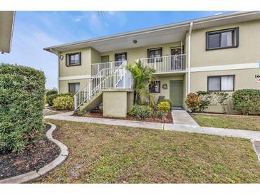 Two-story building exterior with landscaping and a walkway at 25225 Rampart Blvd # 1606, Punta Gorda, FL 33983