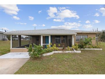 One-story home with screened porch, landscaped yard, and driveway at 30087 Alder Rd, Punta Gorda, FL 33982