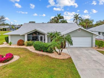 Single-story home with a landscaped lawn, screened porch, and attached garage at 157 Valdiva St, Punta Gorda, FL 33983