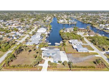 An aerial view showcasing the property's location, canal access, and surrounding neighborhood at 18500 Ohara Dr, Port Charlotte, FL 33948