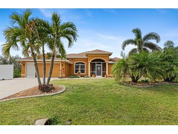 Attractive single-story home with palm trees and landscaped yard at 201 Champion St, Port Charlotte, FL 33953