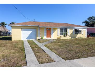 Ranch style home with attached garage, and a large yard at 21094 Edgewater Dr, Port Charlotte, FL 33952