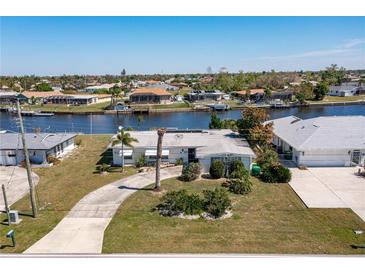 Aerial view of canal front home with large lot and neighborhood at 217 W Tarpon Nw Blvd, Port Charlotte, FL 33952