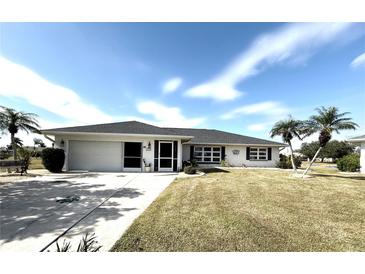 Ranch style home with a two-car garage and landscaped yard at 2219 Bengal Ct, Punta Gorda, FL 33983