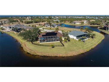 Aerial view of waterfront homes with solar panels and private pools at 24337 Contra Costa Ln, Punta Gorda, FL 33955