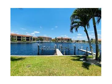 Canal front view with boat docks and lush landscaping at 3311 Wood Thrush Dr # 111, Punta Gorda, FL 33950