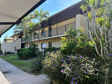 Two-story condo building with balconies, lush landscaping, and a walkway at 4008 Oakview Dr # K3, Punta Gorda, FL 33980