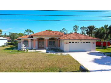 Single-story home with tile roof, fountain, and two-car garage at 108 Mccabe St, Port Charlotte, FL 33953