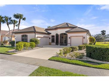 Single-story home with a tile roof, three-car garage, and landscaped yard at 2408 Silver Palm Rd, North Port, FL 34288