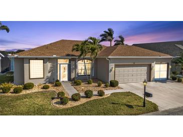 Attractive single-story home with landscaped yard and two-car garage at 24424 Buckingham Way, Punta Gorda, FL 33980