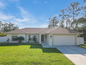 Single-story house with a two-car garage and a well-manicured lawn at 2970 Cascabel Ter, North Port, FL 34286